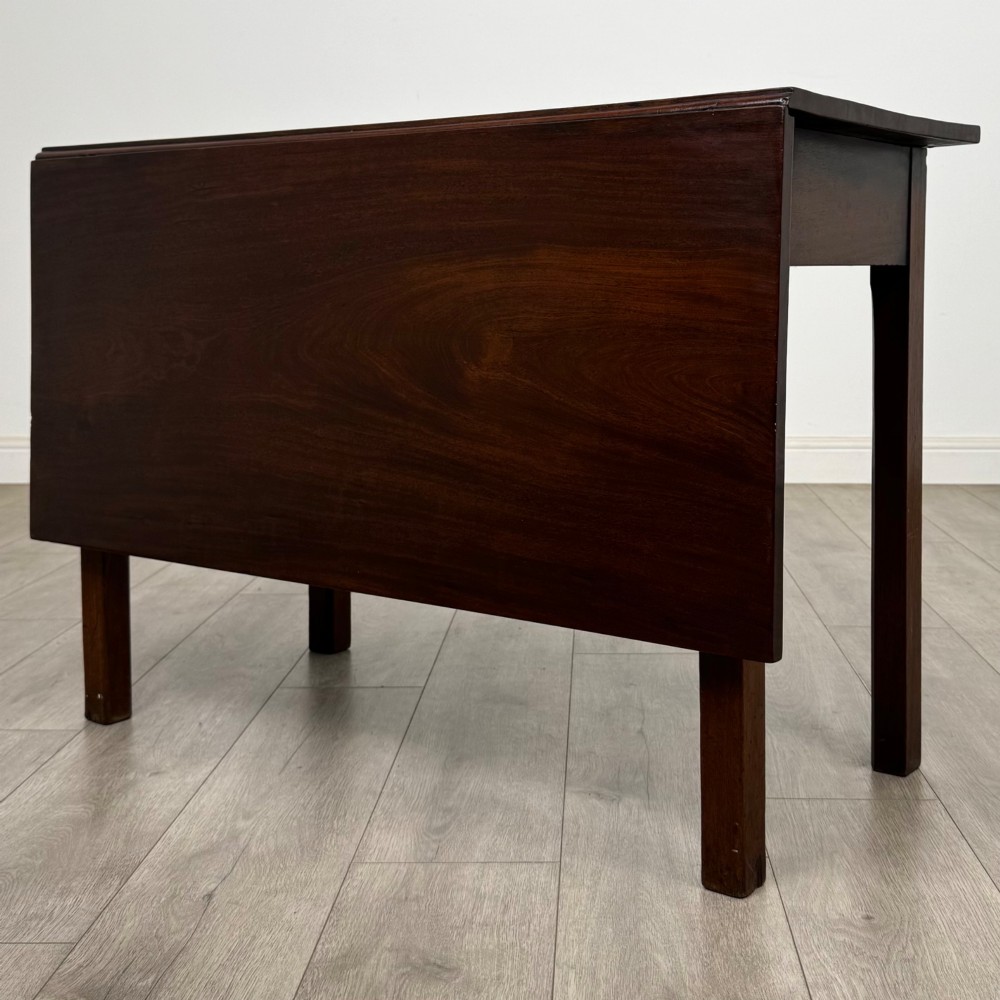 An 18th-century Georgian mahogany writing table featuring a rectangular top, a single wide frieze drawer with brass handles and central escutcheon, supported by straight square legs. View VII