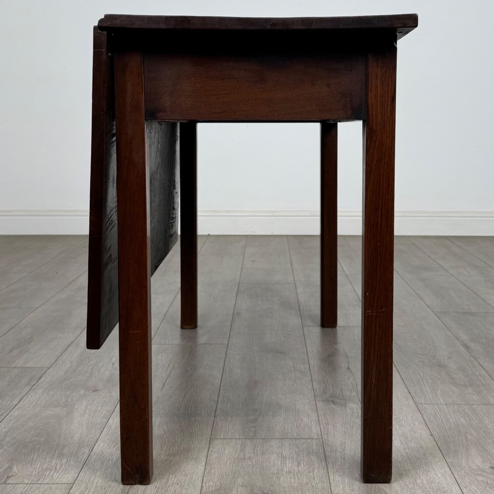 An 18th-century Georgian mahogany writing table featuring a rectangular top, a single wide frieze drawer with brass handles and central escutcheon, supported by straight square legs. View VIII