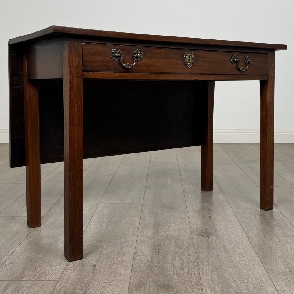An 18th-century Georgian mahogany writing table featuring a rectangular top, a single wide frieze drawer with brass handles and central escutcheon, supported by straight square legs. View IX