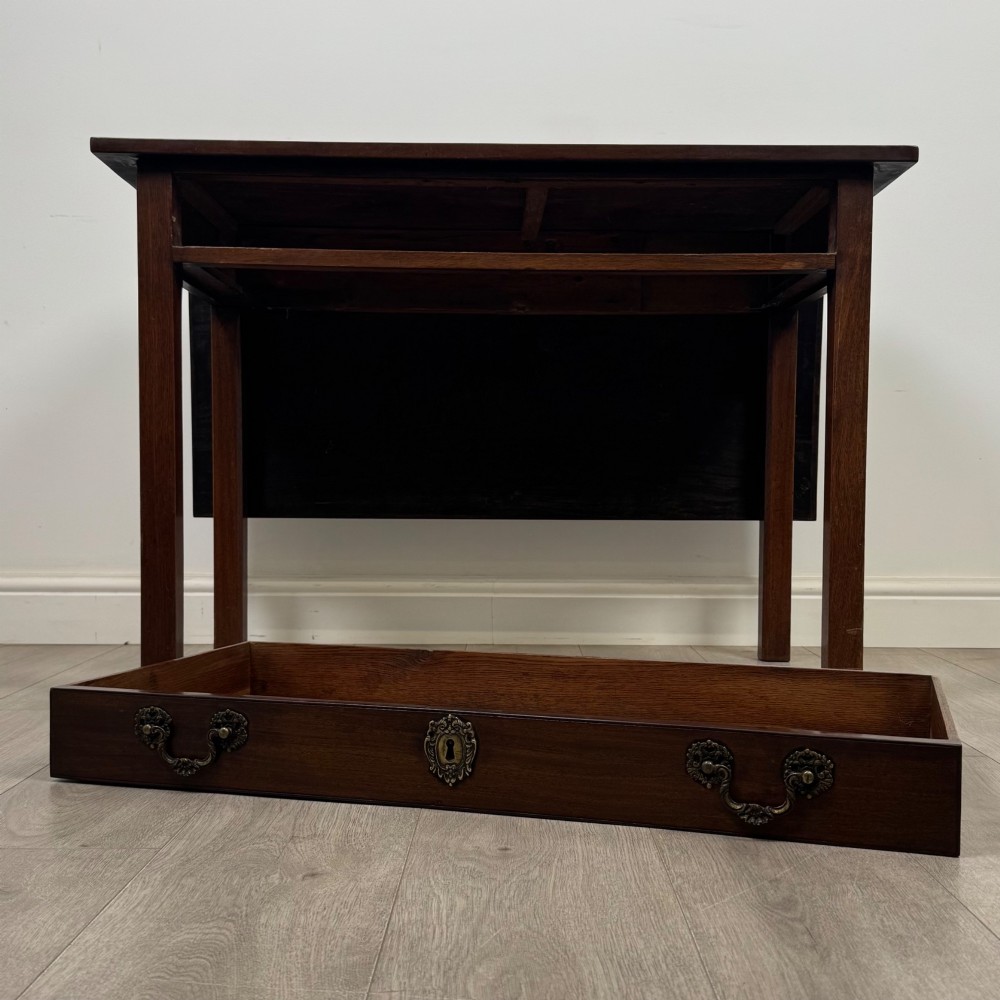An 18th-century Georgian mahogany writing table featuring a rectangular top, a single wide frieze drawer with brass handles and central escutcheon, supported by straight square legs. View XII