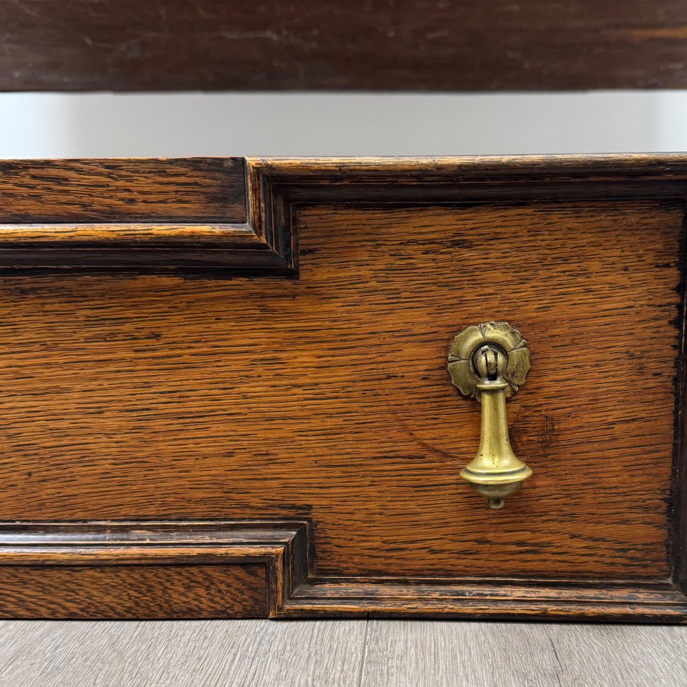 A 20th-century Jacobean style dark oak sideboard with a central leaded glass cupboard, geometric moulded drawers and doors, turned legs, and stretchers. View XII
