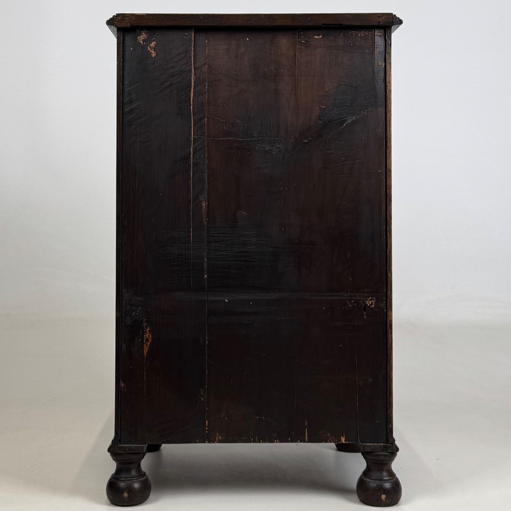 A small Edwardian carved dark oak cabinet with a single top drawer, a lower cupboard door, turned wooden knobs, and bun feet. View VI