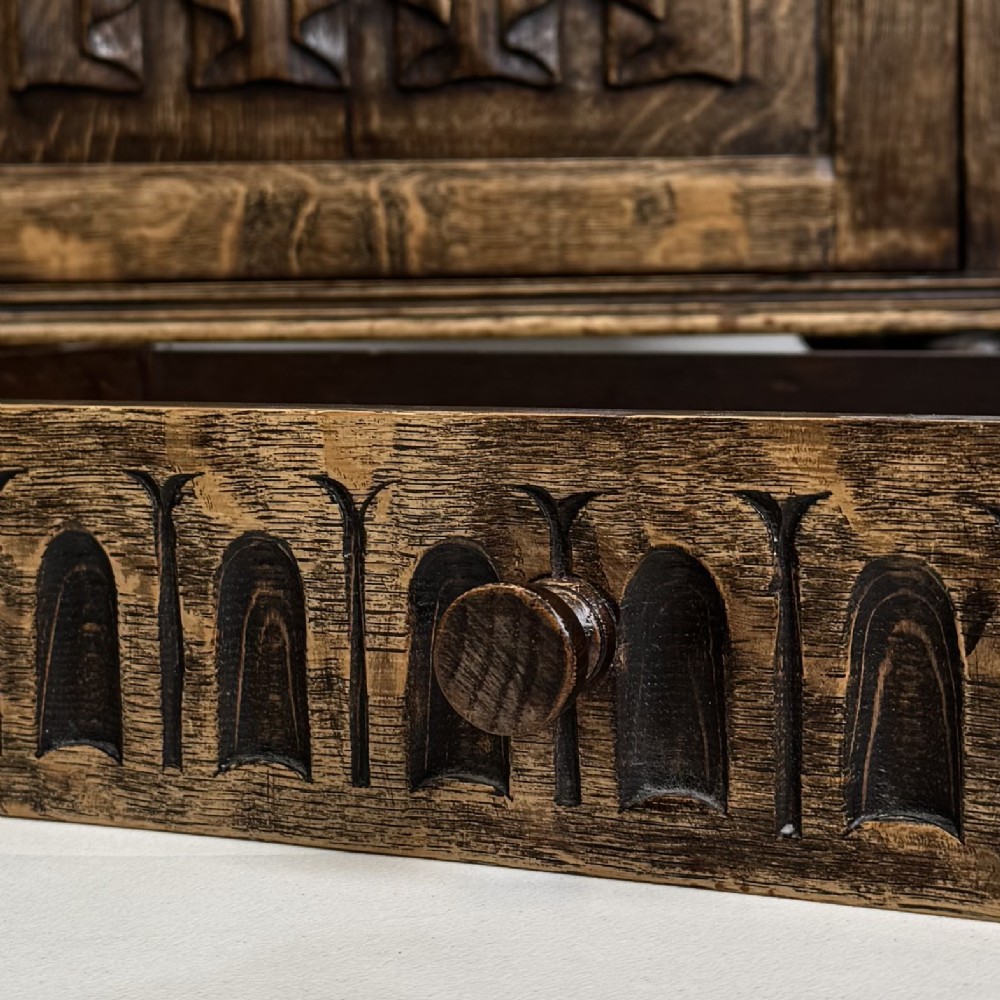 A small Edwardian carved dark oak cabinet with a single top drawer, a lower cupboard door, turned wooden knobs, and bun feet. View XIII