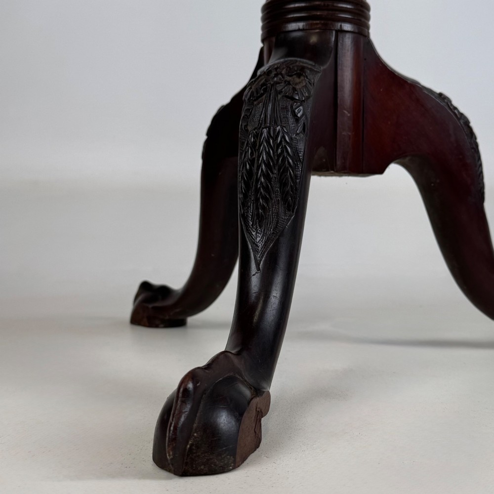 A tall Victorian dark mahogany plant stand featuring a carved fluted column, acanthus leaf details, and a tripod base. View V