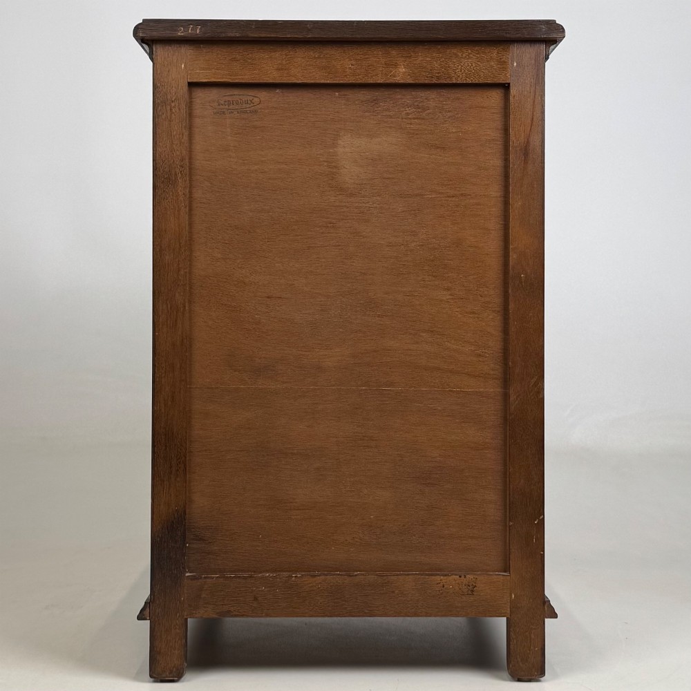 A small dark oak Edwardian chest featuring four drawers with brass drop handles and turned bun feet. View V
