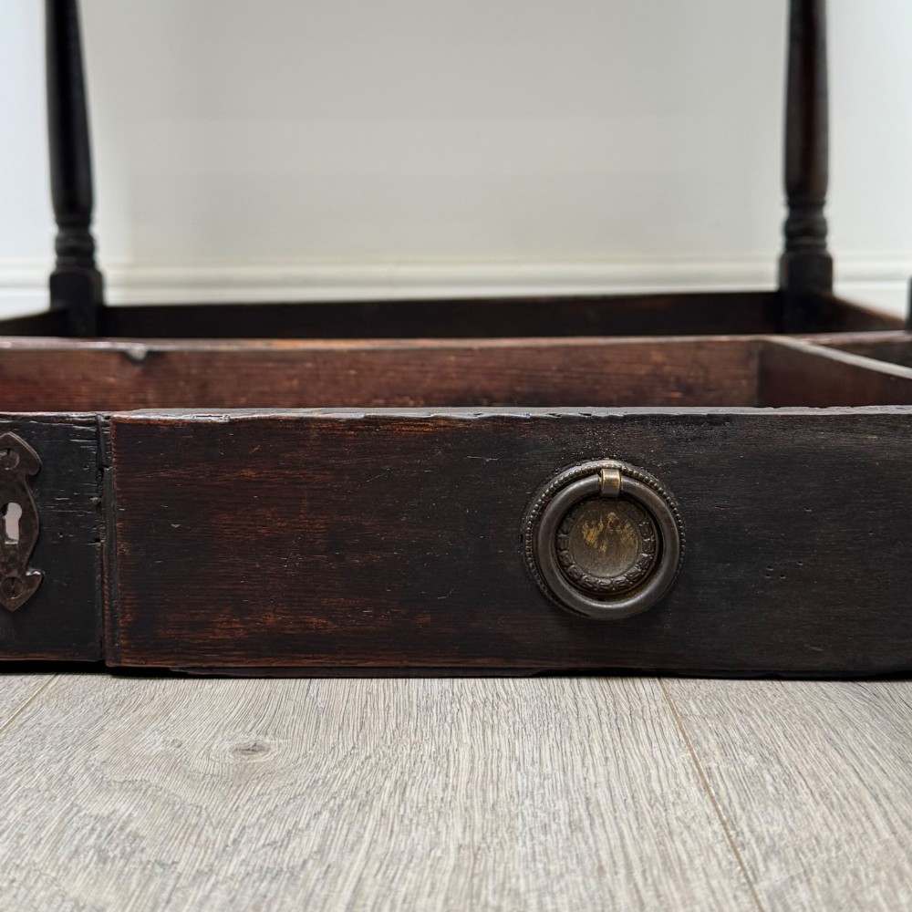 An 18th-century dark oak side table featuring turned legs, a scalloped apron frieze, a single drawer with brass hardware, and perimeter stretchers. View XI