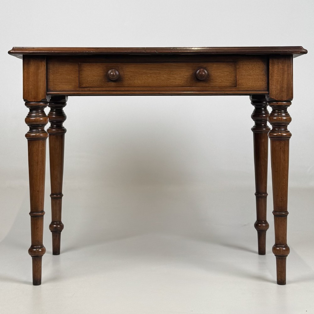 A 19th-century Victorian mahogany side table featuring a single drawer with two turned wooden handles and four turned legs.
