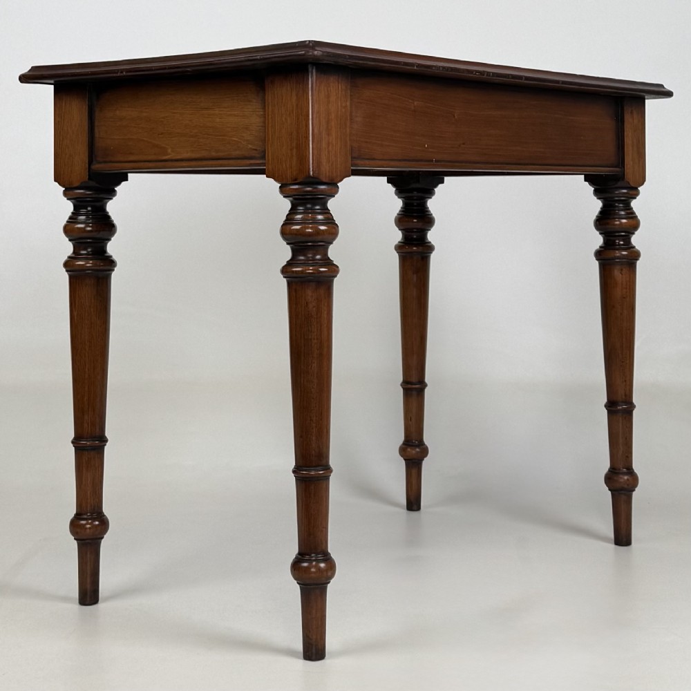 A 19th-century Victorian mahogany side table featuring a single drawer with two turned wooden handles and four turned legs. View IV
