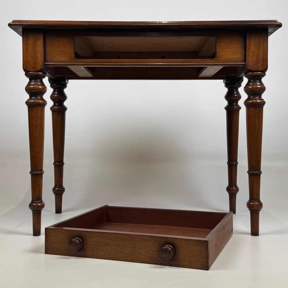 A 19th-century Victorian mahogany side table featuring a single drawer with two turned wooden handles and four turned legs. View X