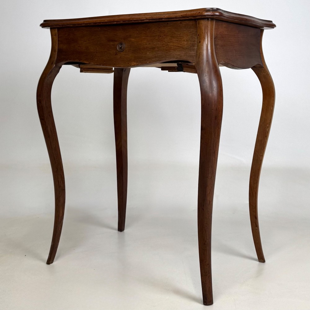 A 19th-century French mahogany side table featuring high cabriole legs, a single frieze drawer with a brass keyhole, and a shaped apron. View II