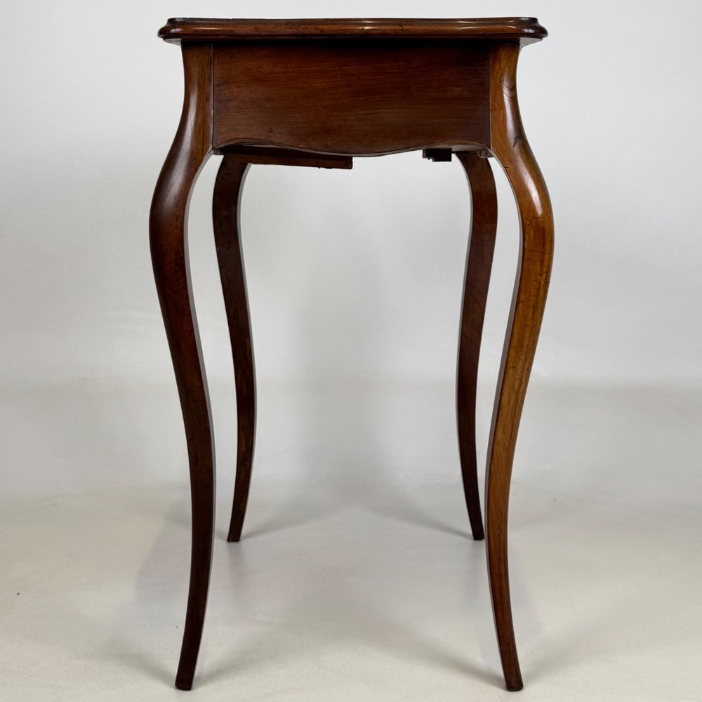 A 19th-century French mahogany side table featuring high cabriole legs, a single frieze drawer with a brass keyhole, and a shaped apron. View III
