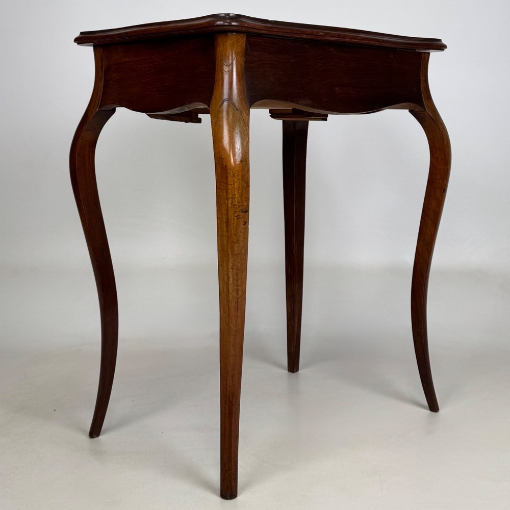 A 19th-century French mahogany side table featuring high cabriole legs, a single frieze drawer with a brass keyhole, and a shaped apron. View IV