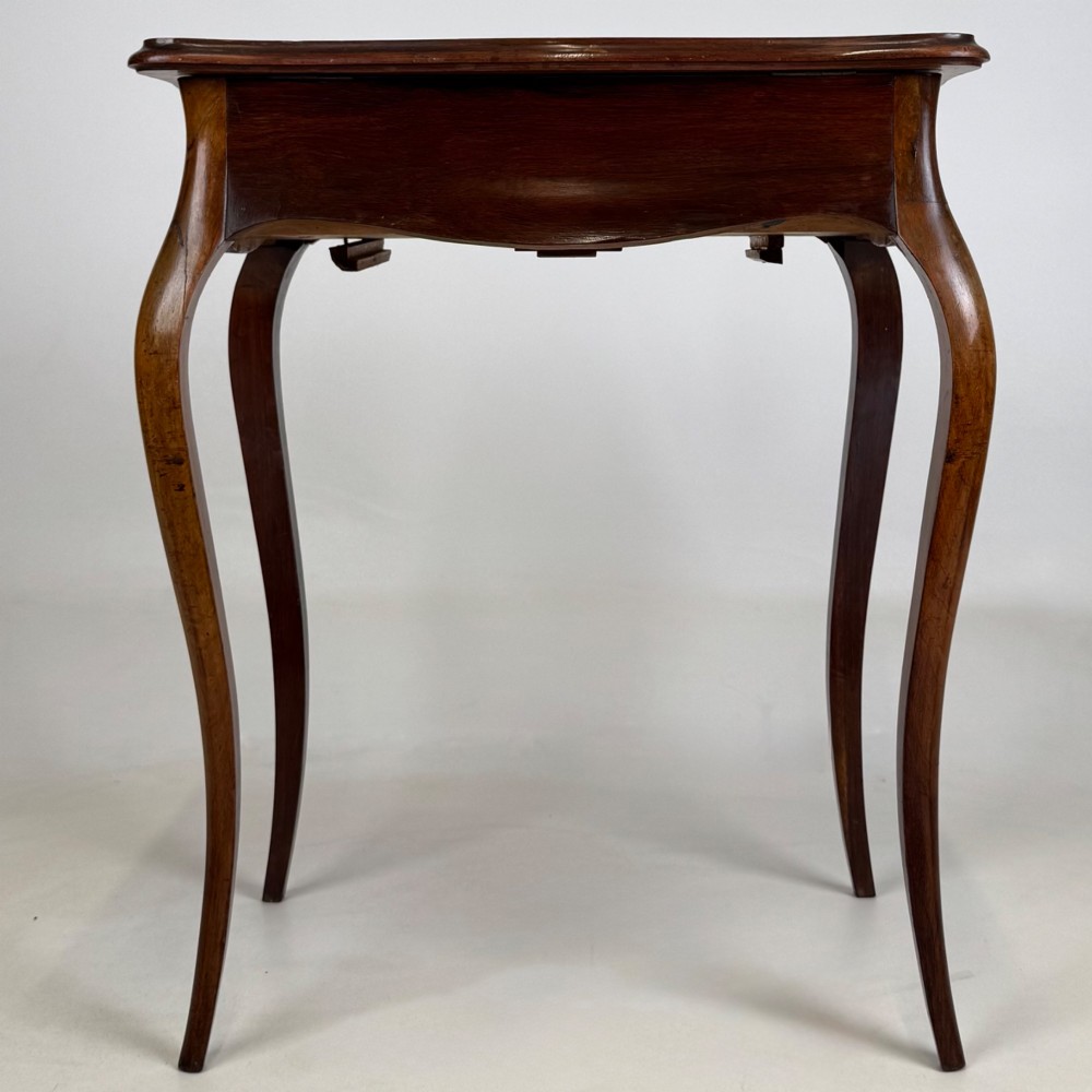 A 19th-century French mahogany side table featuring high cabriole legs, a single frieze drawer with a brass keyhole, and a shaped apron. View V