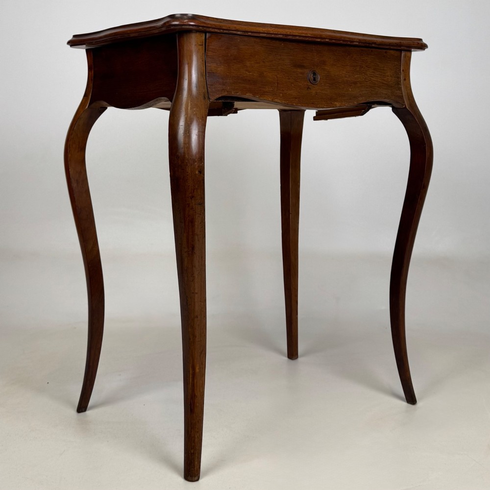 A 19th-century French mahogany side table featuring high cabriole legs, a single frieze drawer with a brass keyhole, and a shaped apron. View VIII