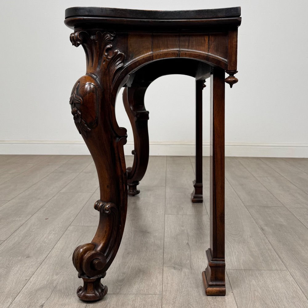 A 19th-century Victorian rosewood side table featuring hand-carved C-scroll ornament, a serpentine apron, and carved cabriole legs. View III