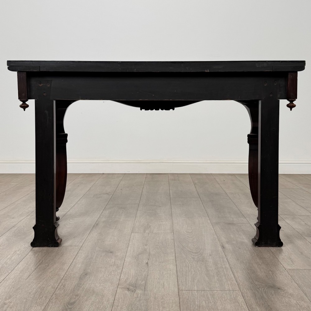 A 19th-century Victorian rosewood side table featuring hand-carved C-scroll ornament, a serpentine apron, and carved cabriole legs. View V