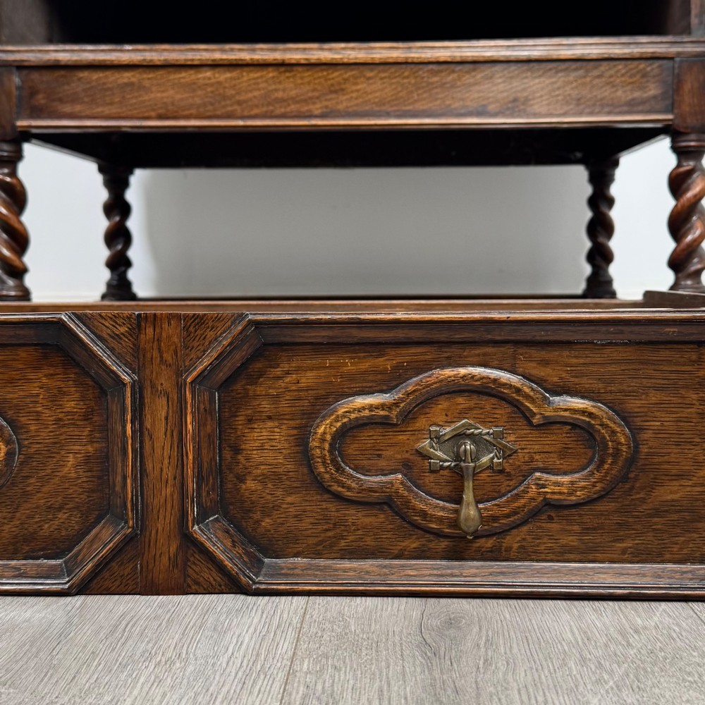 A dark oak Jacobean revival slant-front bureau featuring geometric panel mouldings, drop handles, and barley twist legs joined by stretchers. View XIII