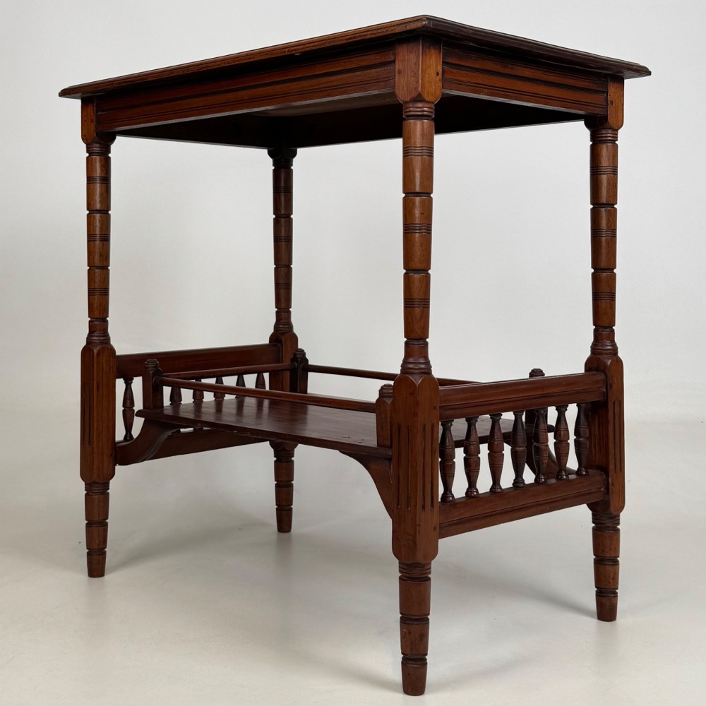 An Edwardian mahogany side table featuring turned legs and a lower shelf enclosed with spindle side rails. View II