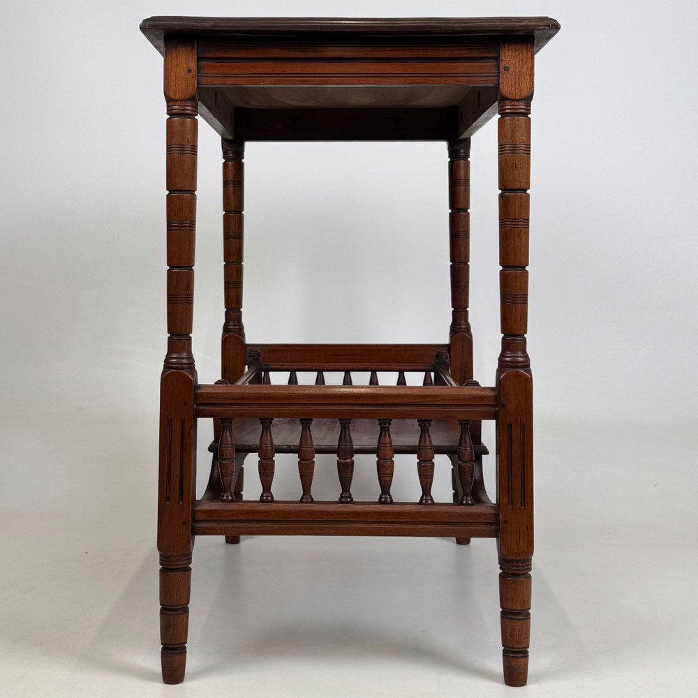 An Edwardian mahogany side table featuring turned legs and a lower shelf enclosed with spindle side rails. View III