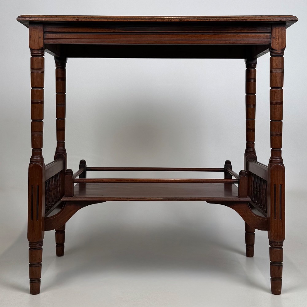 An Edwardian mahogany side table featuring turned legs and a lower shelf enclosed with spindle side rails. View V