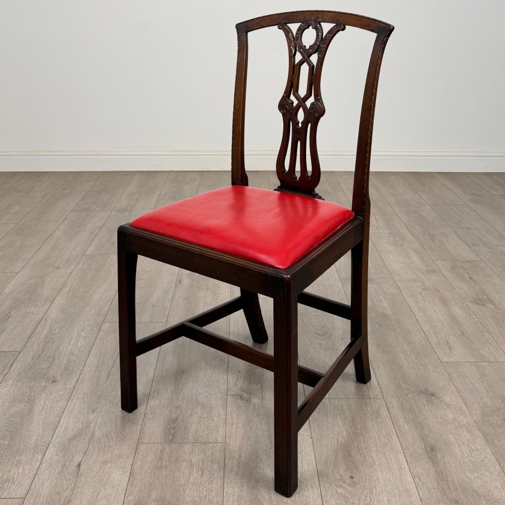 A set of six dark mahogany Georgian dining chairs featuring pierced back splats, straight legs with stretchers, and bright red leather drop-in seats. View III