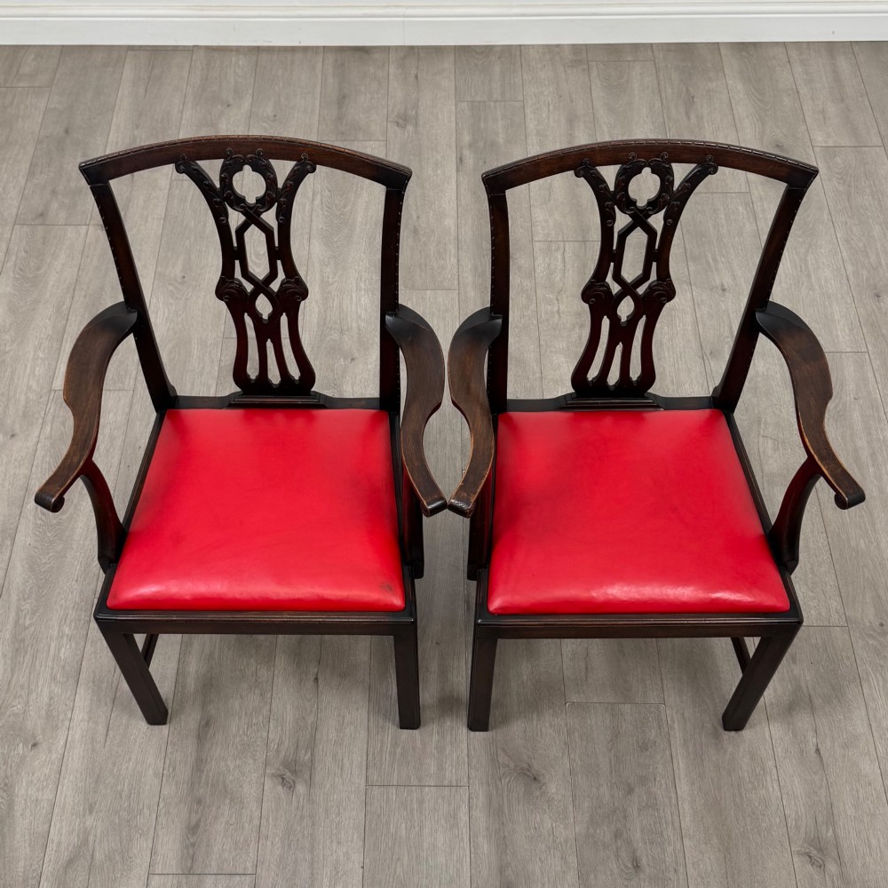 A set of six dark mahogany Georgian dining chairs featuring pierced back splats, straight legs with stretchers, and bright red leather drop-in seats. View IX