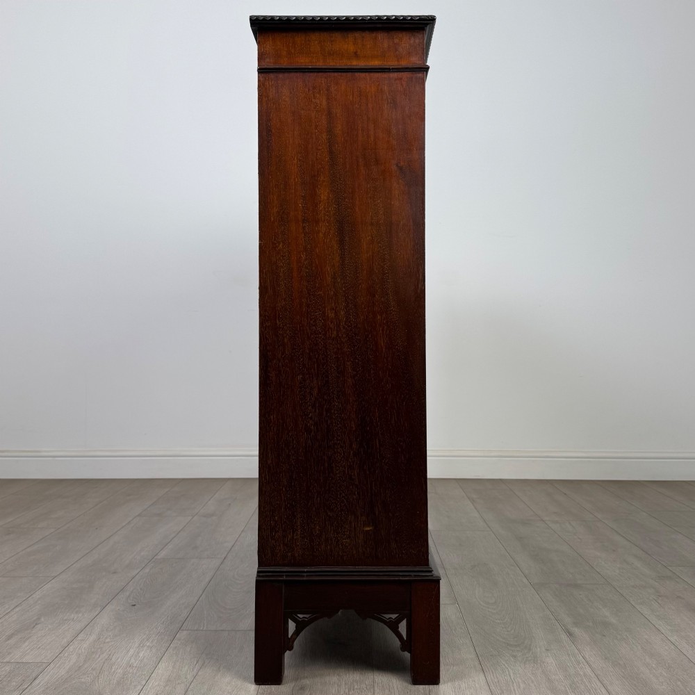 An Edwardian dark mahogany display cabinet featuring two glass doors with interlaced astragal glazing bars and internal wooden shelves. View VIII
