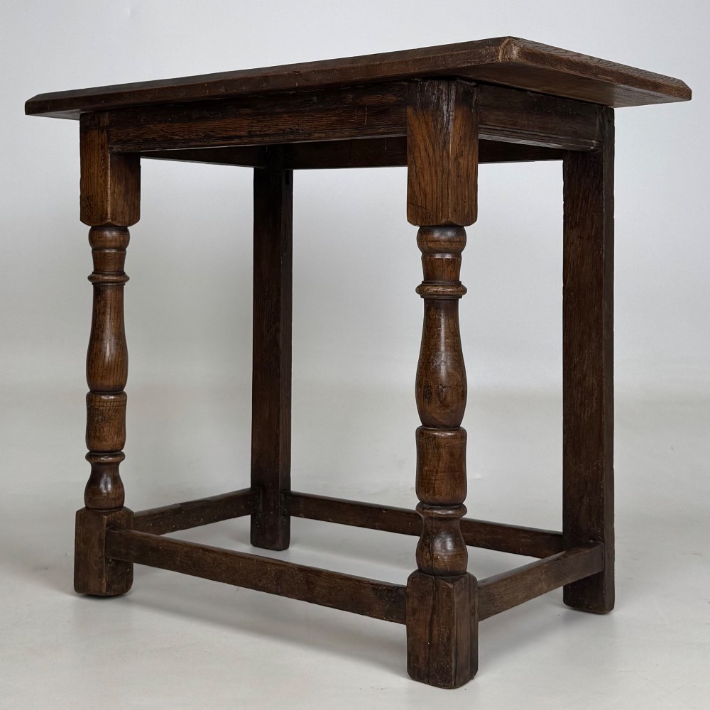 A 19th-century dark oak side table featuring a rectangular flat top, turned baluster legs, and sturdy lower stretchers. View II