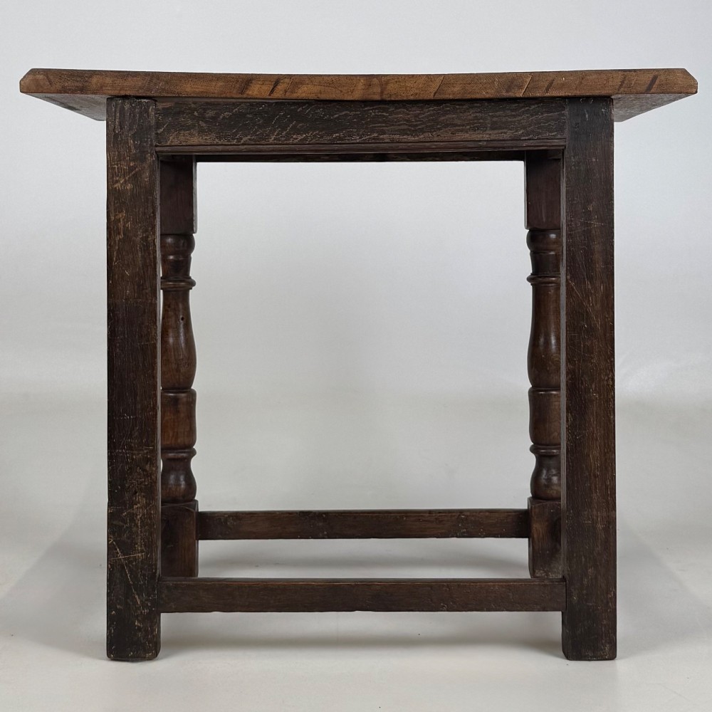 A 19th-century dark oak side table featuring a rectangular flat top, turned baluster legs, and sturdy lower stretchers. View V