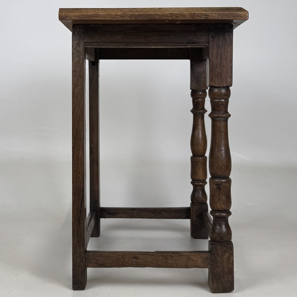 A 19th-century dark oak side table featuring a rectangular flat top, turned baluster legs, and sturdy lower stretchers. View VII