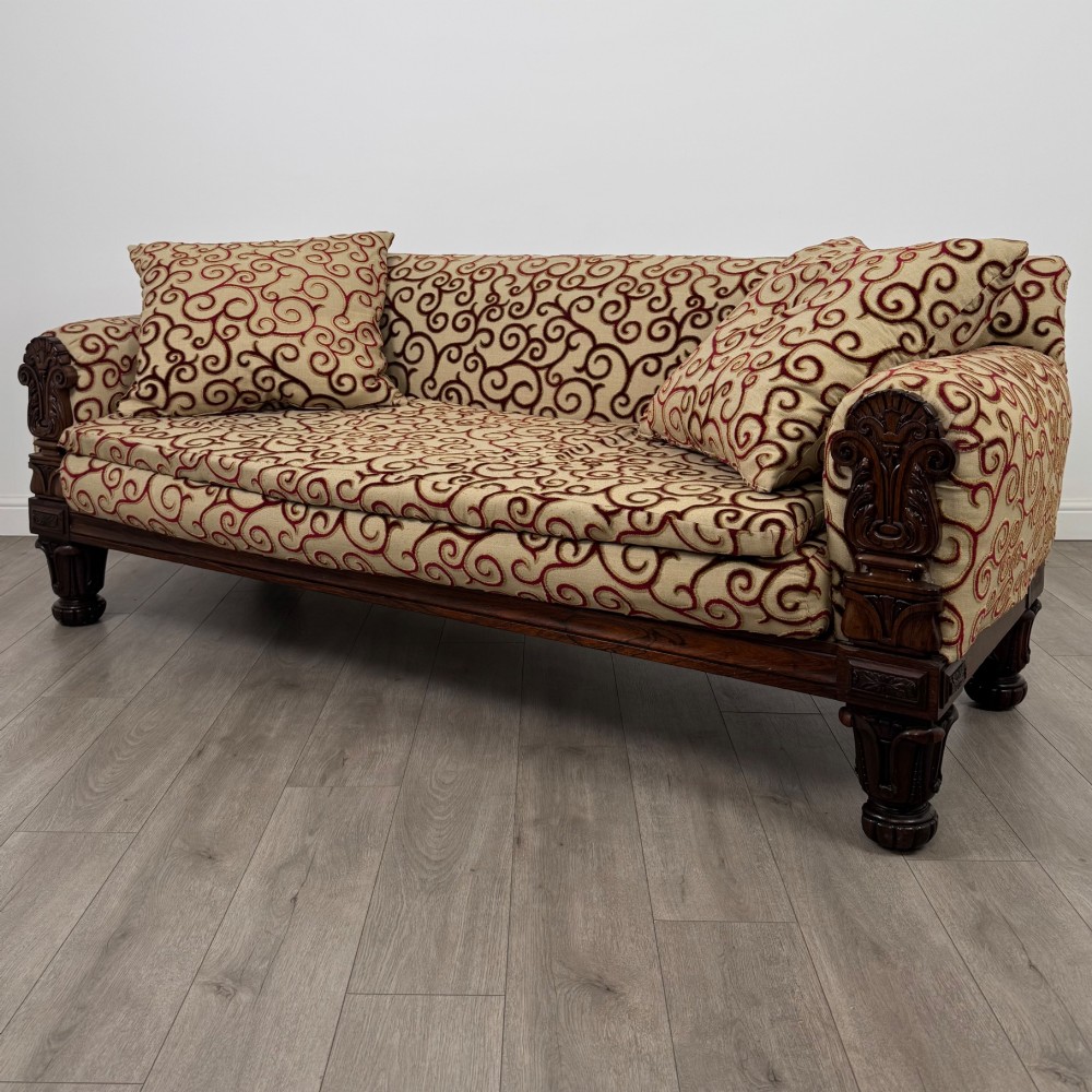 A 19th-century William IV sofa crafted from dark rosewood with carved scroll arms, turned legs, and swirl-patterned cream and burgundy fabric upholstery. View II