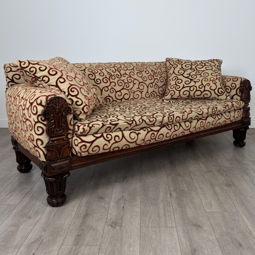 A 19th-century William IV sofa crafted from dark rosewood with carved scroll arms, turned legs, and swirl-patterned cream and burgundy fabric upholstery. View VIII