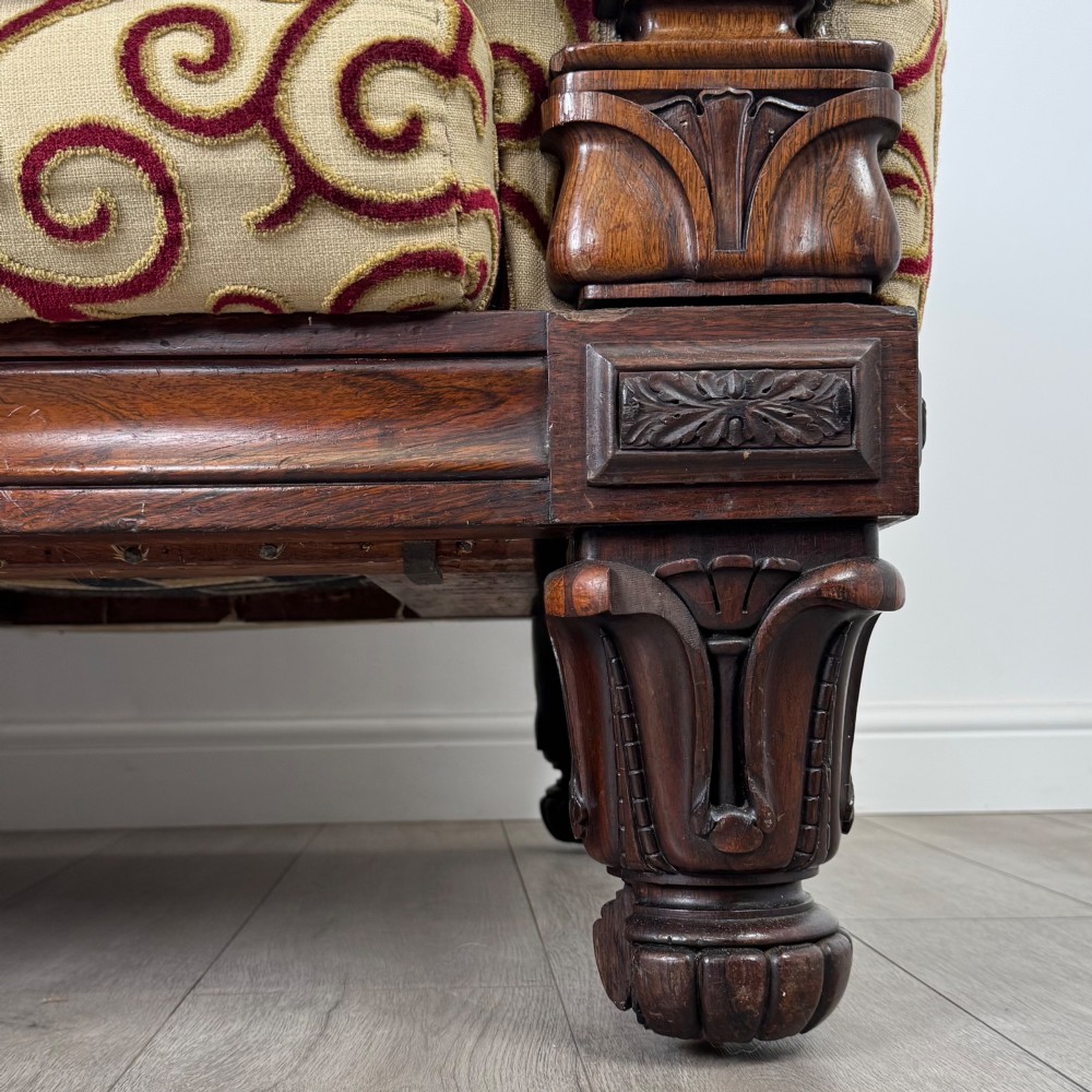 A 19th-century William IV sofa crafted from dark rosewood with carved scroll arms, turned legs, and swirl-patterned cream and burgundy fabric upholstery. View XI