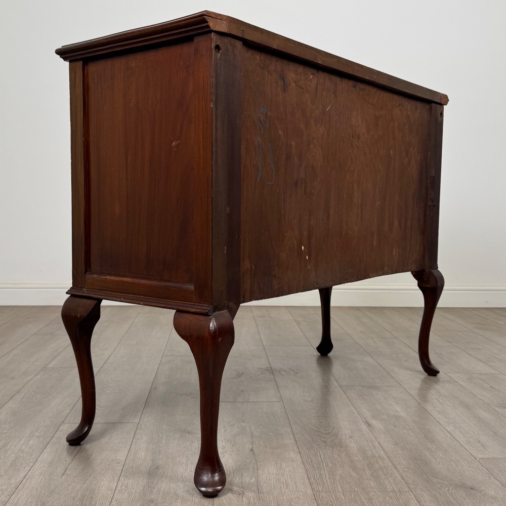 An Edwardian mahogany sideboard featuring two top drawers above a two-door cabinet supported on slender cabriole legs. View V