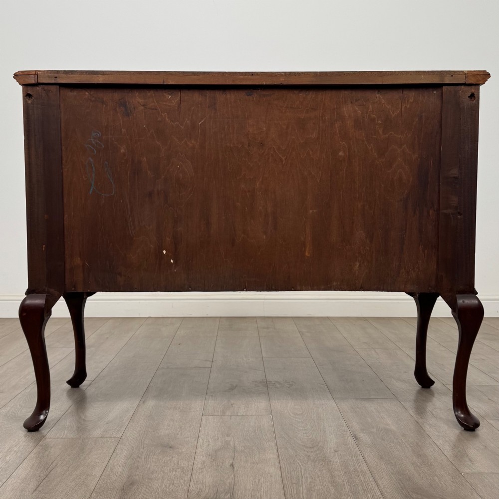 An Edwardian mahogany sideboard featuring two top drawers above a two-door cabinet supported on slender cabriole legs. View VI