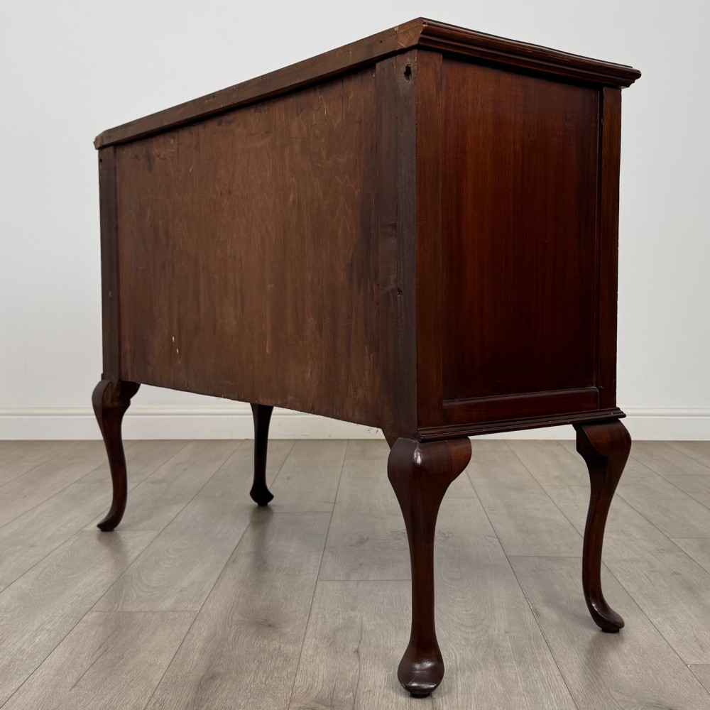 An Edwardian mahogany sideboard featuring two top drawers above a two-door cabinet supported on slender cabriole legs. View VII