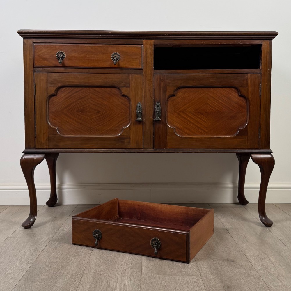 An Edwardian mahogany sideboard featuring two top drawers above a two-door cabinet supported on slender cabriole legs. View XI