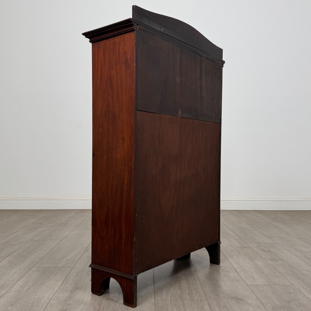 An Edwardian dark mahogany cabinet with an open upper shelf, two lower inlaid cupboard doors, and shaped bracket feet. View VI