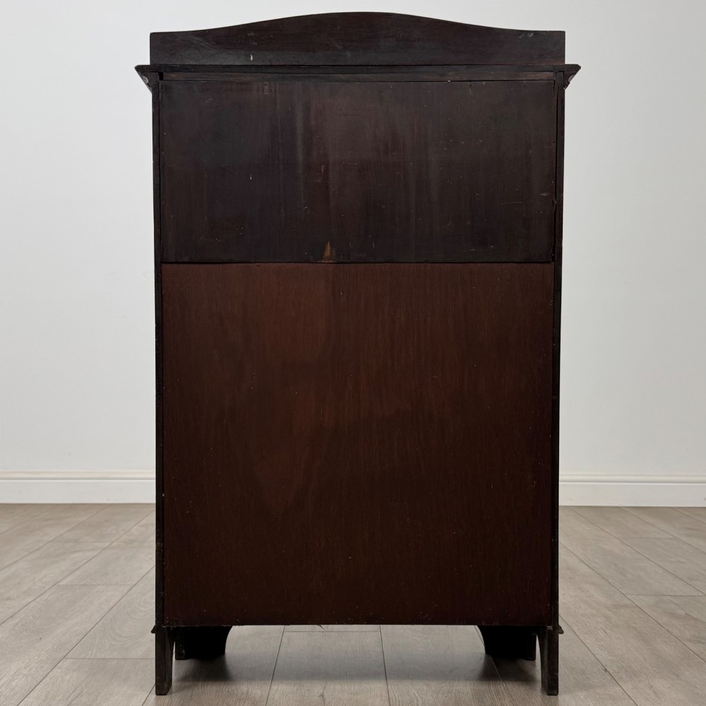 An Edwardian dark mahogany cabinet with an open upper shelf, two lower inlaid cupboard doors, and shaped bracket feet. View VII