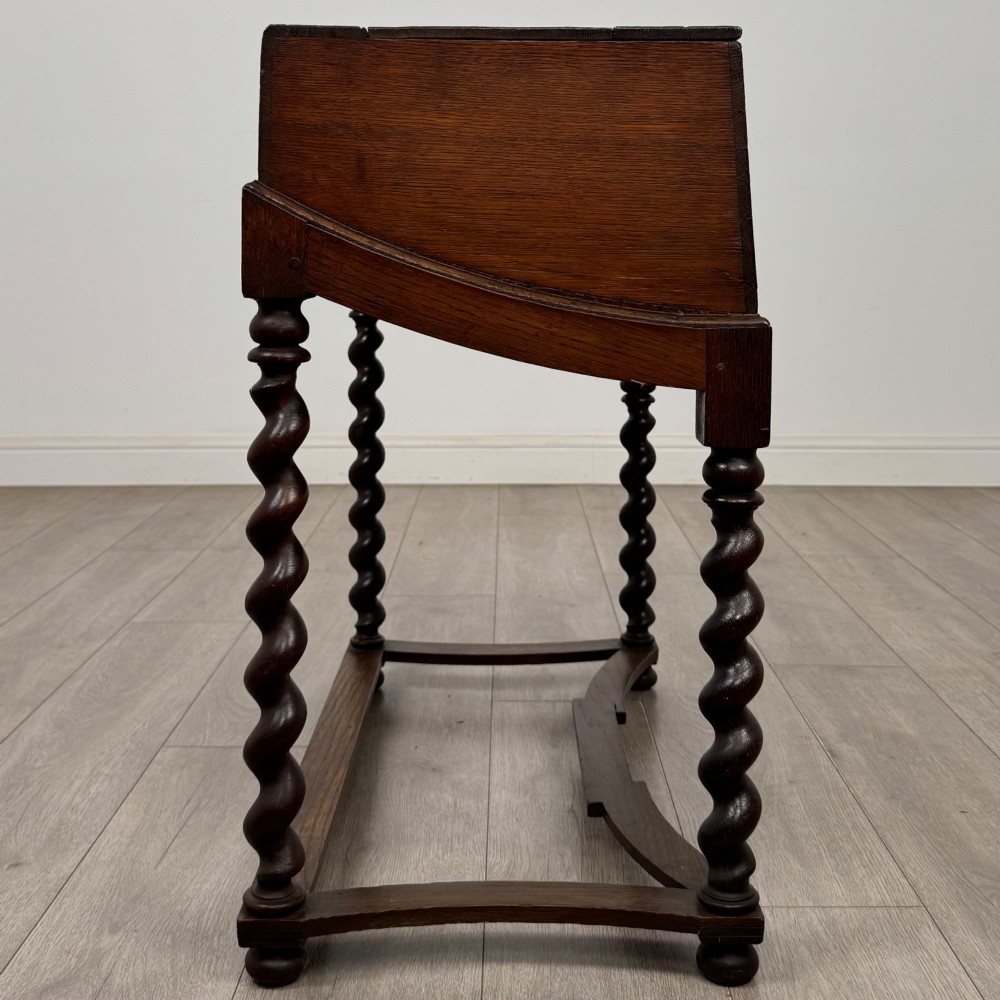 A 19th-century dark oak box on a wooden stand featuring four spiral barley twist legs and a central brass keyhole escutcheon. View VII