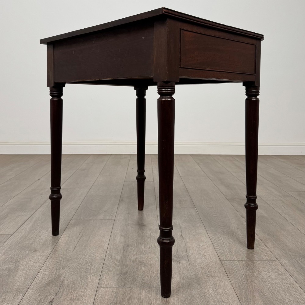 An antique dark mahogany Georgian side table featuring a single drawer with two brass sunburst knobs and slender turned legs. View VI
