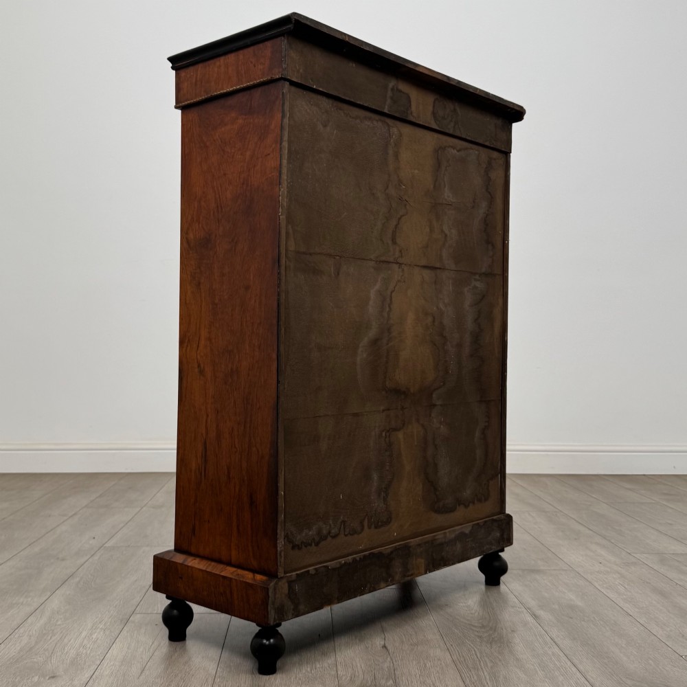 A 19th-century Victorian walnut pier cabinet featuring floral marquetry inlays, gilded metal mounts, and a single glazed door revealing interior shelves. View V