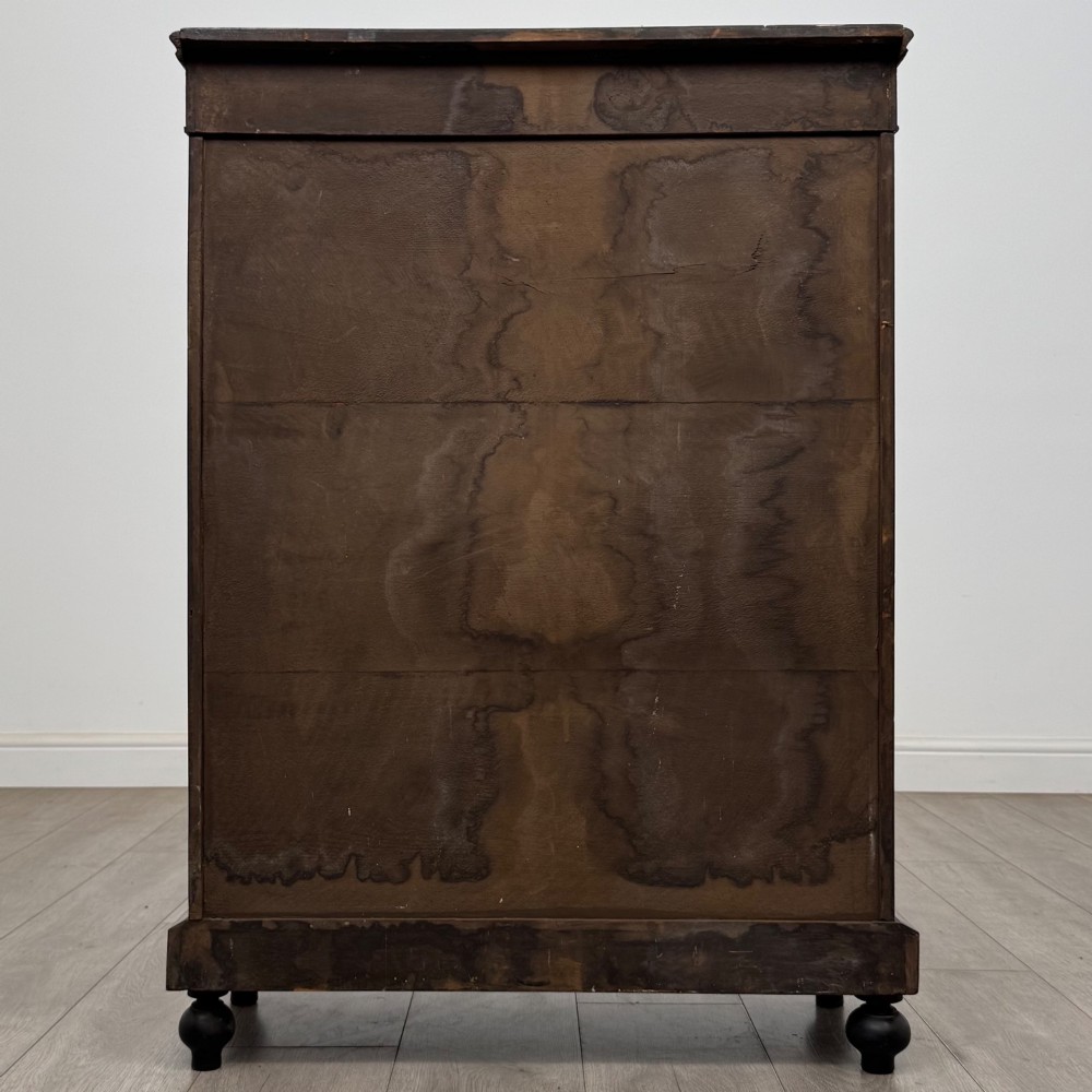 A 19th-century Victorian walnut pier cabinet featuring floral marquetry inlays, gilded metal mounts, and a single glazed door revealing interior shelves. View VI
