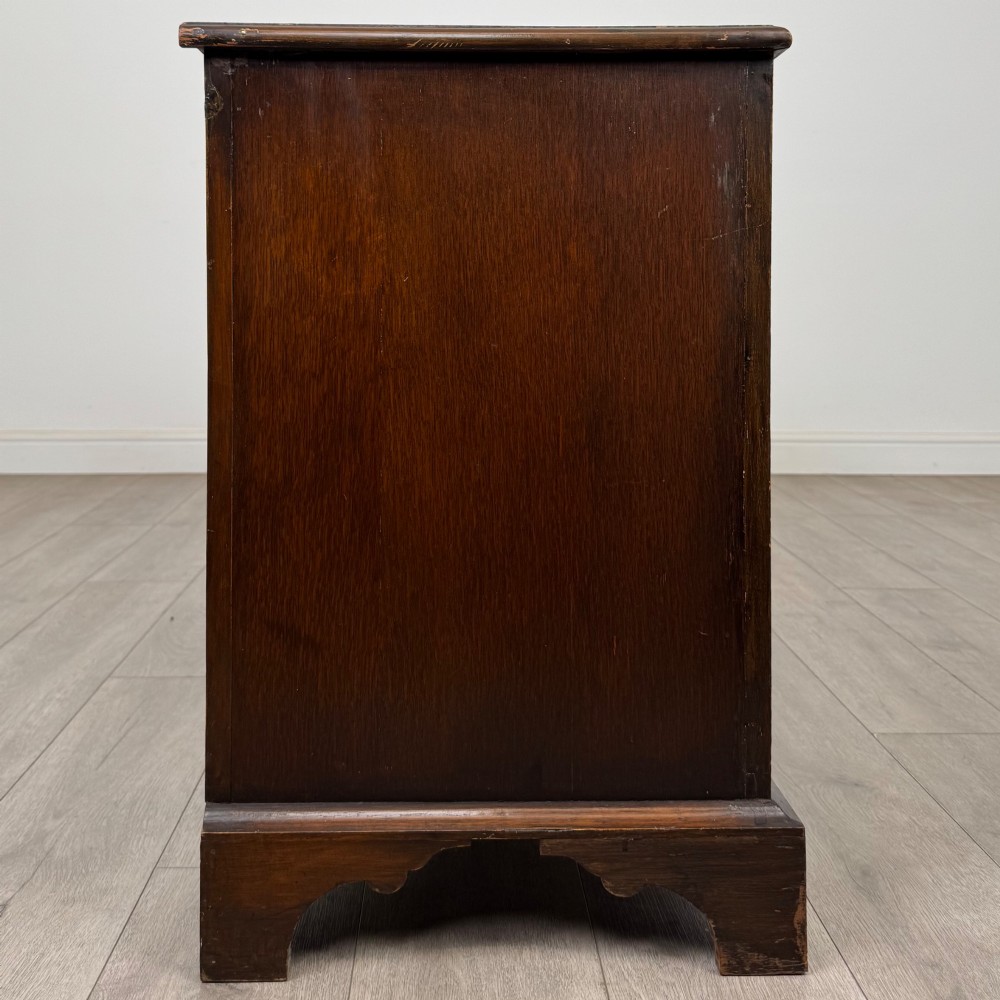 A dark oak sideboard featuring two carved upper drawers above panelled cupboard doors with decorative iron hinges and wooden knobs. View VIII