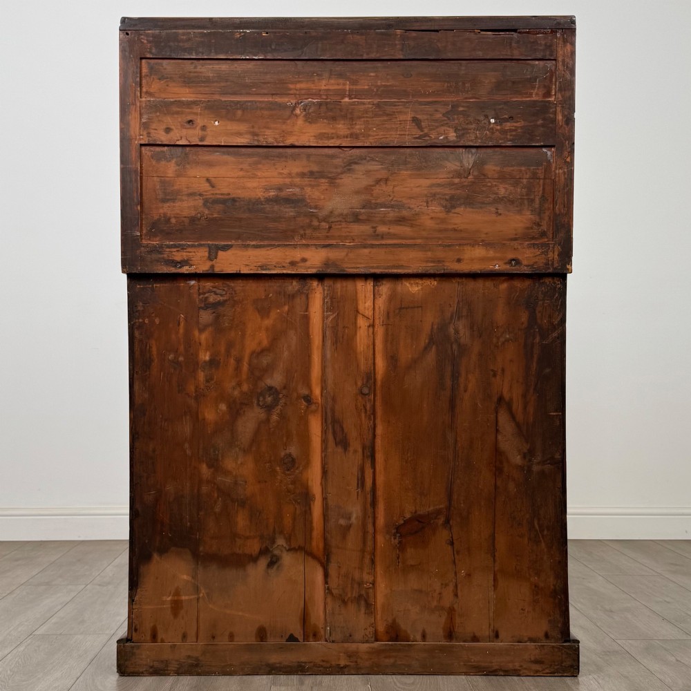 An antique Regency mahogany chiffonier featuring an upper two-tier shelf structure, a long drawer with star-shaped brass pulls, and a lower panelled double cupboard on a plinth base. View VI