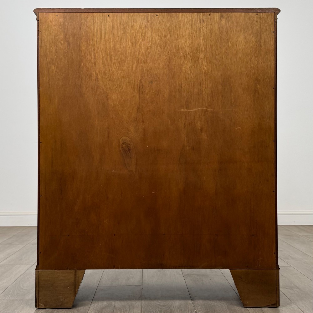A 20th-century burr walnut display cabinet featuring two glazed doors with arched detail above two drawers on bracket feet. View VI