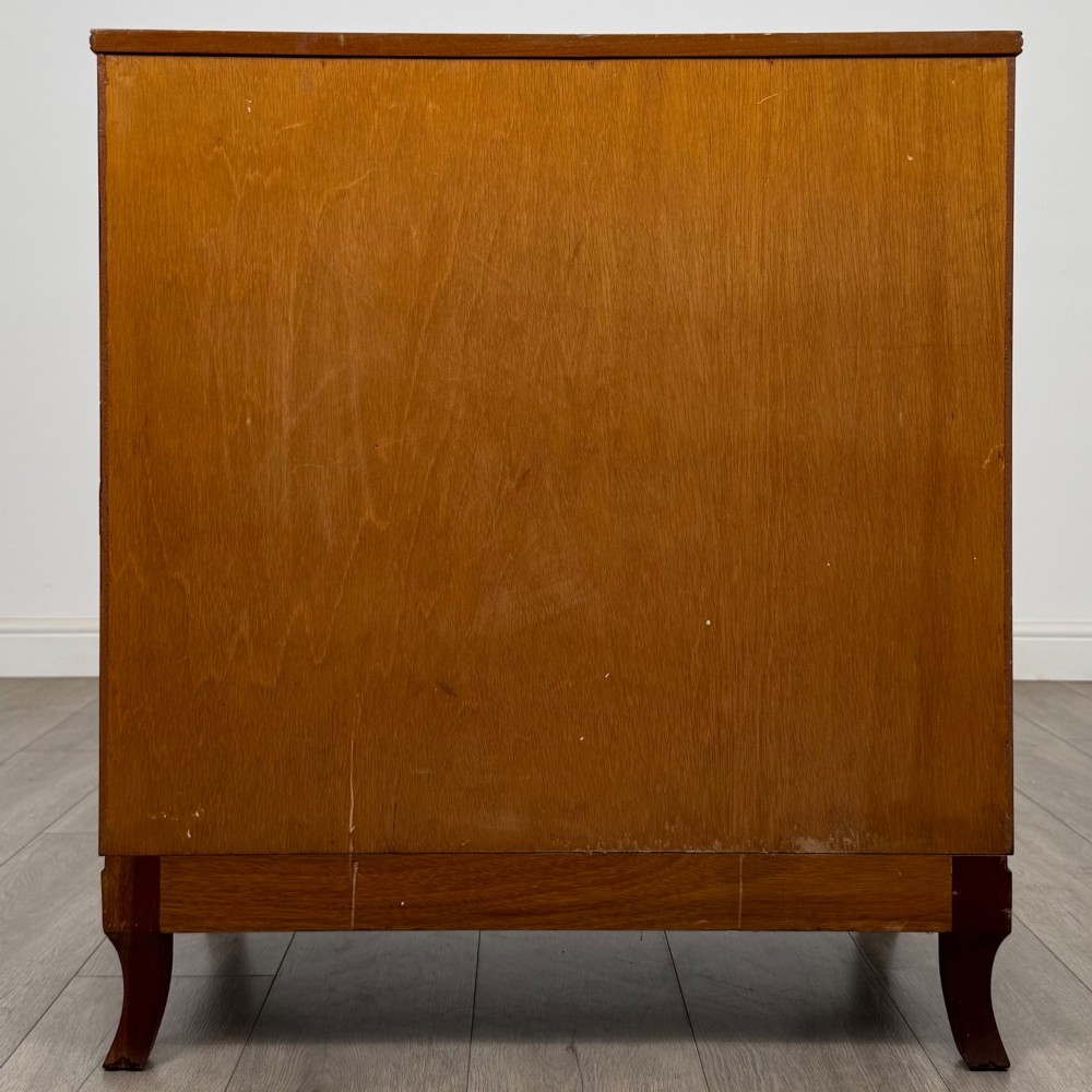 A mahogany chest of four drawers featuring decorative inlaid borders, circular brass drop handles, and bracket feet. View V