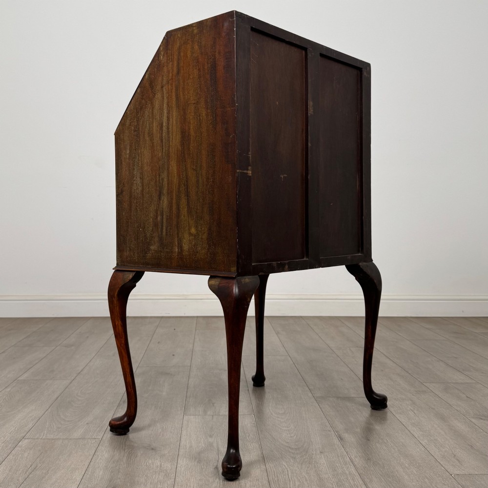 An Edwardian mahogany writing bureau featuring a sloped drop-front lid above two drawers, supported by four slender cabriole legs. View V