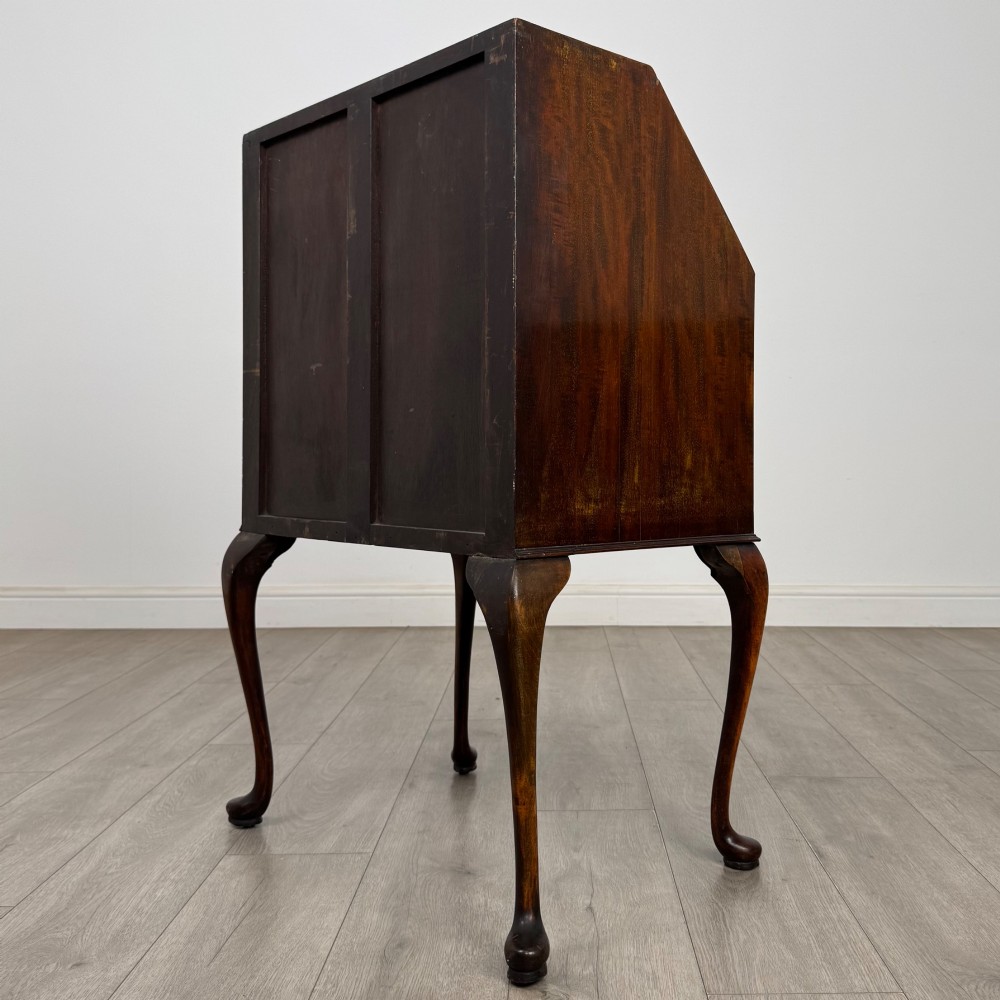 An Edwardian mahogany writing bureau featuring a sloped drop-front lid above two drawers, supported by four slender cabriole legs. View VII