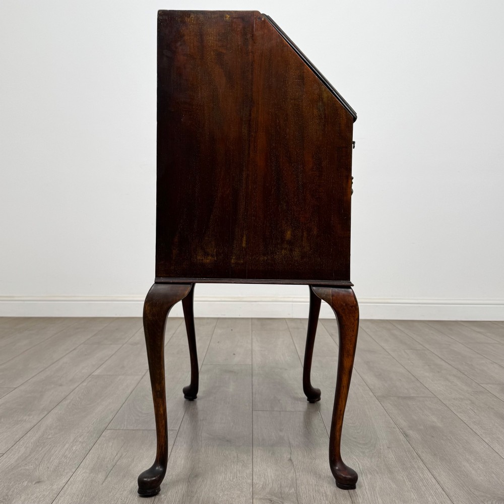 An Edwardian mahogany writing bureau featuring a sloped drop-front lid above two drawers, supported by four slender cabriole legs. View VIII